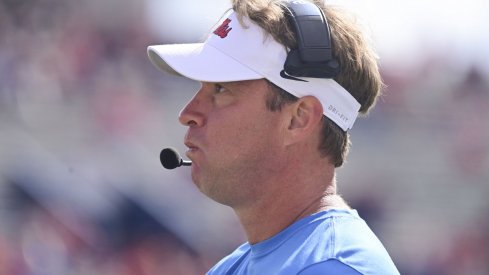 Lane Kiffin stares into the sky with dread.