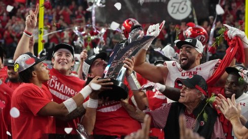 Quarterback Cameron Rising of the Utah Utes Holding the Pac-12 Championship Trophy